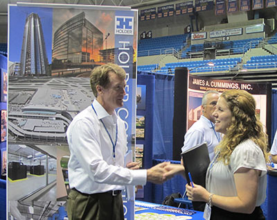 Holder vice president Wayne Wadsworth meets a student at UF's career fair.