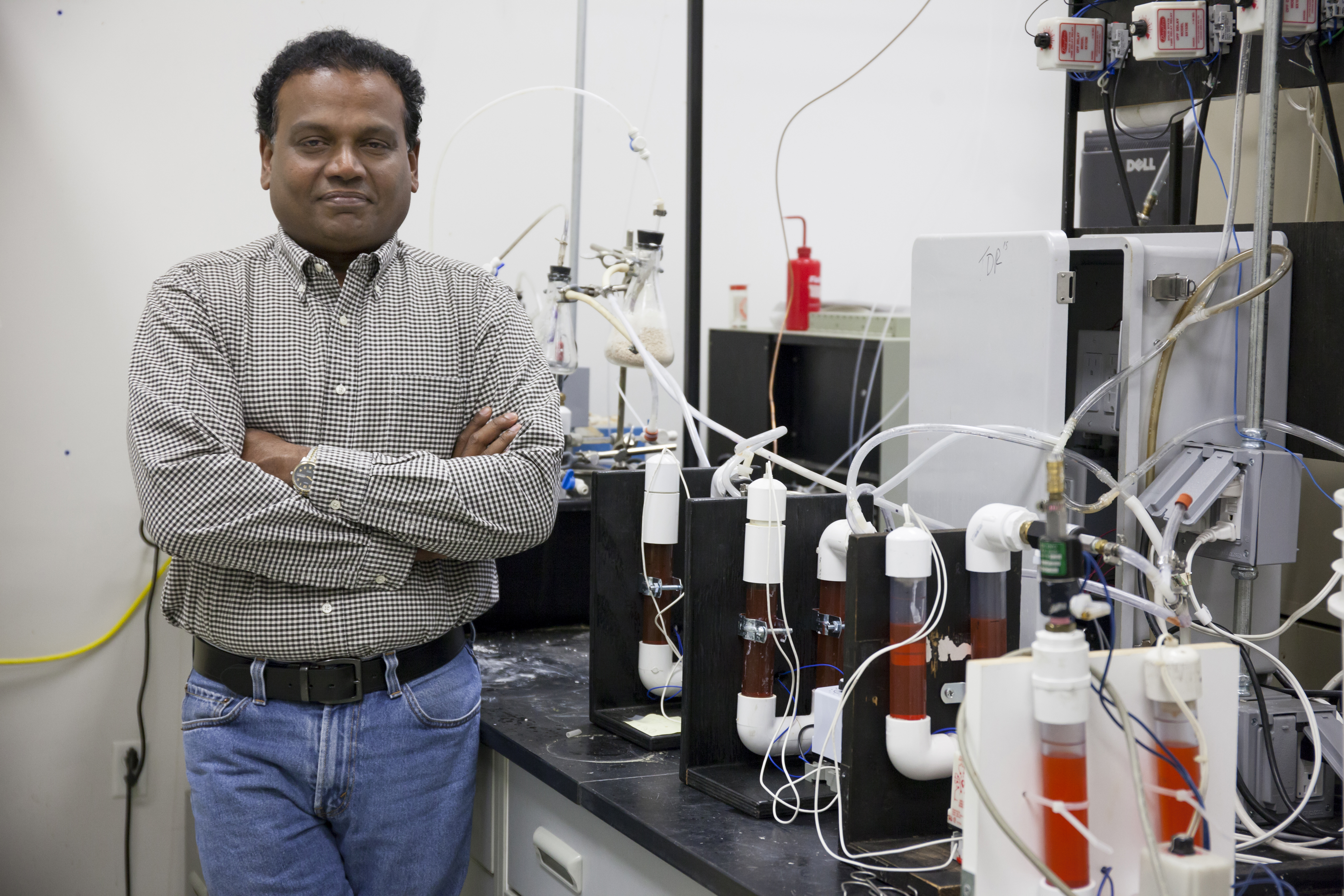 Pratap Pullammanappallil, a UF associate professor of agricultural and biological engineering, poses with an anaerobic digester used in a process he developed at NASA’s request to turn human waste into rocket fuel. Photo by Amy Stuart, UF/IFAS Communications.