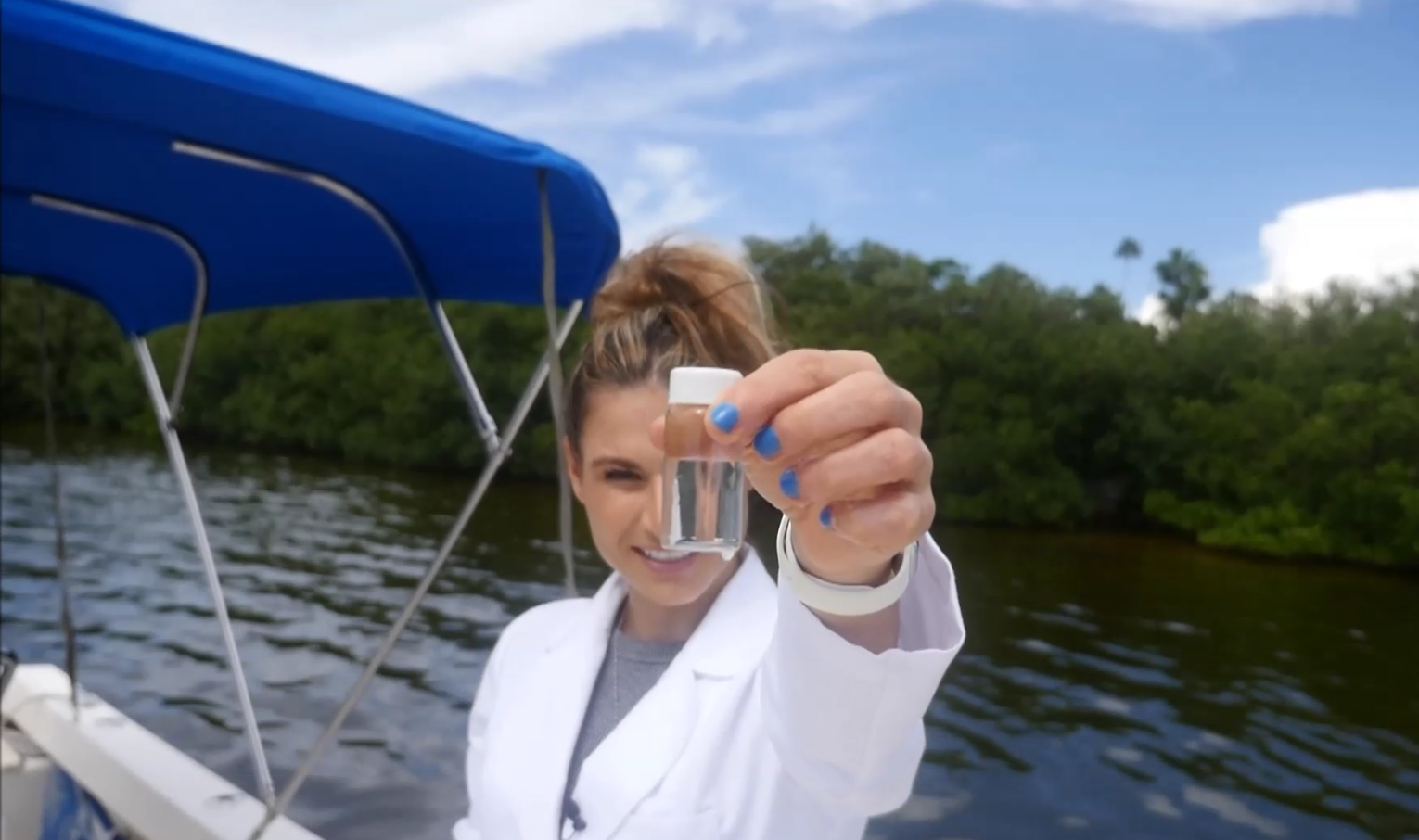 dr. tracy fanara holds a water sample