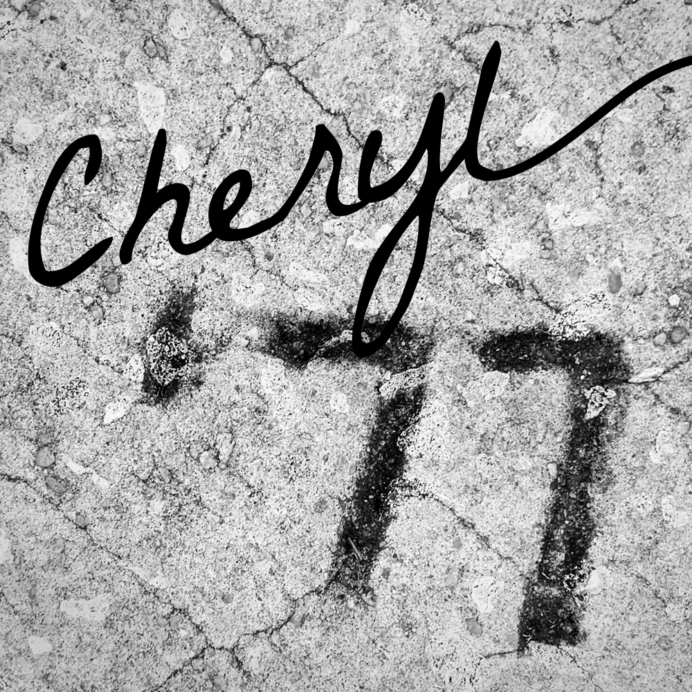 the number 77 in concrete with the word Cheryl in script laid over it