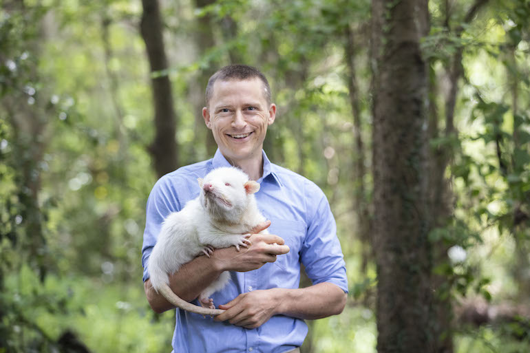 doctoral grad philip stark with his albino opossum Conan