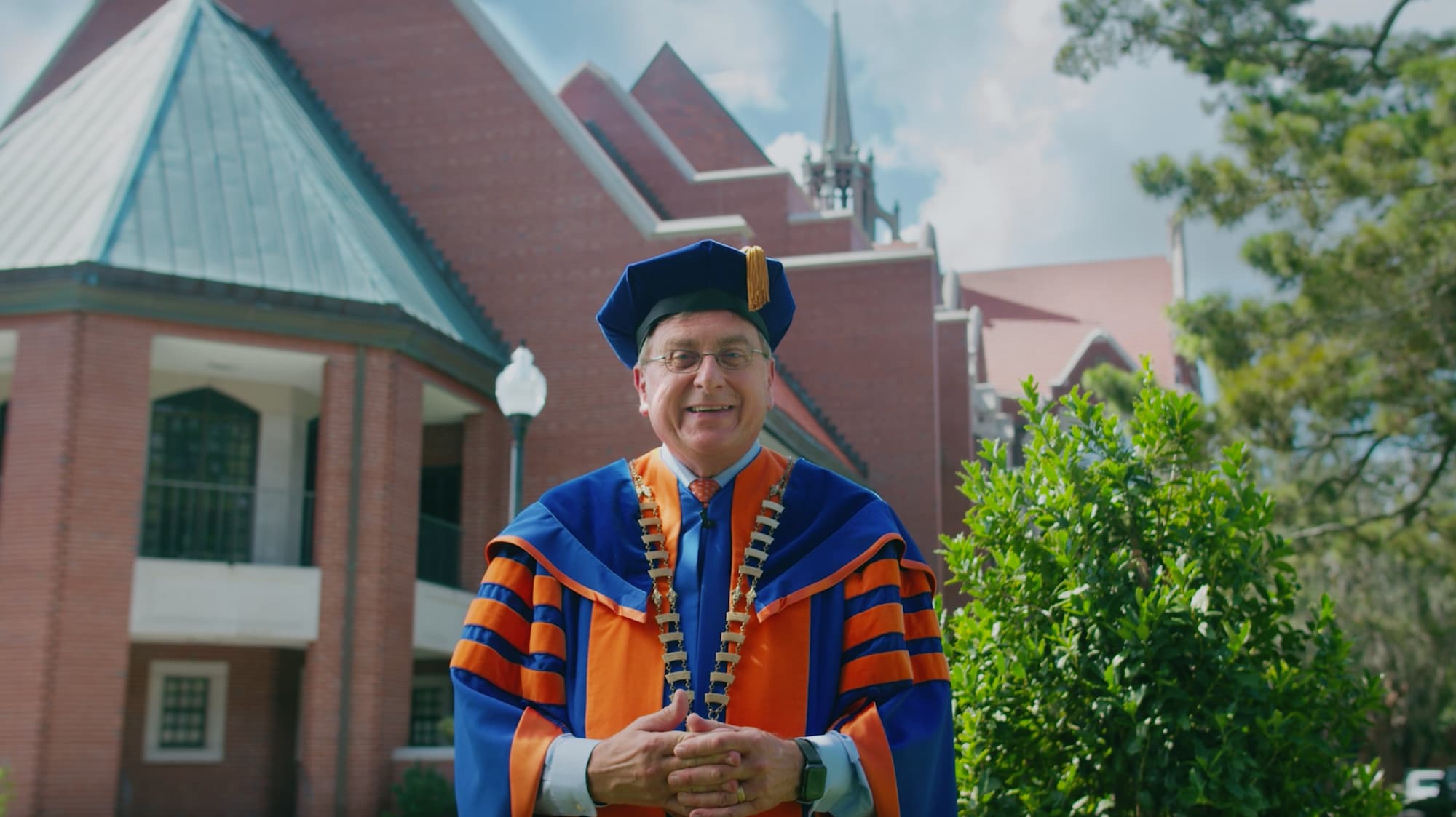 UF president Kent Fuchs in graduation regalia in front of University Auditorium