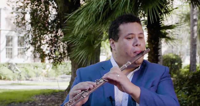 Jose Ruiz on UF campus playing flute