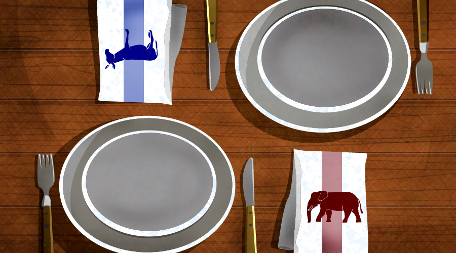 A napkin with a donkey and a napkin with an elephant sit on a dinner table