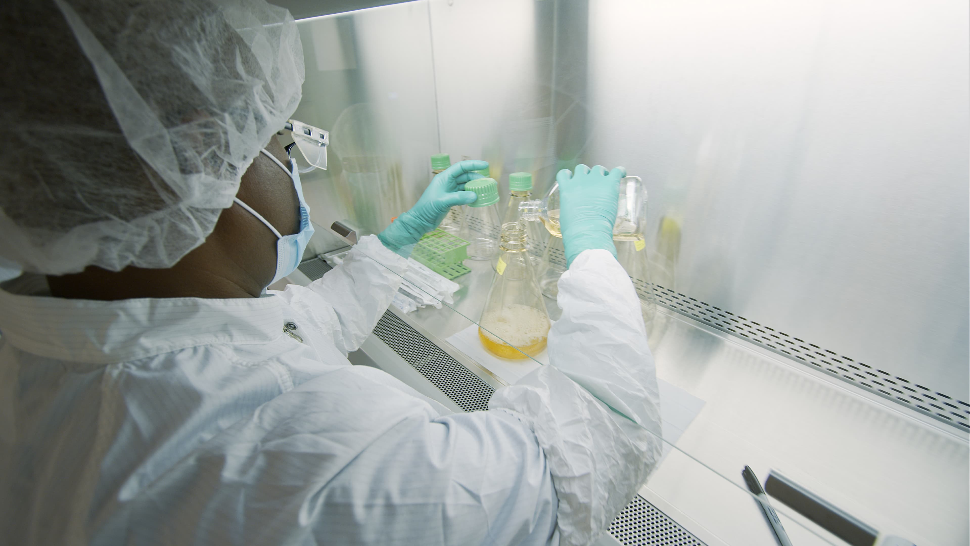 A laboratory worker at Eli Lilly prepares a solution used to manufacture bamlanivimab, a new monoclonal antibody therapy for COVID-19. 