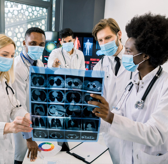 A group of medical professionals examine an X-Ray.