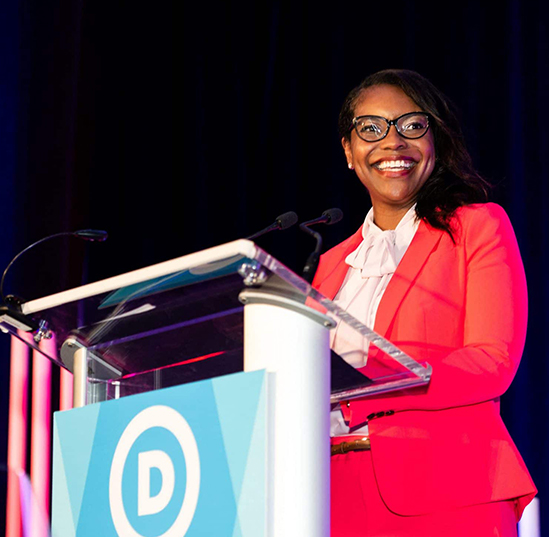 Emilia Sykes, this year’s Ohio House of Representative’s minority leader, stands in front of a lectern adorned with the Ohio Democrats' logo 