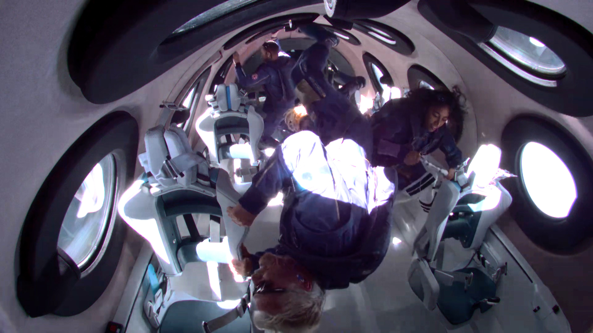 Astronaut Sirisha Bandla, right, can be seen activating a Kennedy Space Center Fixation Tube just as the Virgin Galactic spaceship reaches zero gravity. 