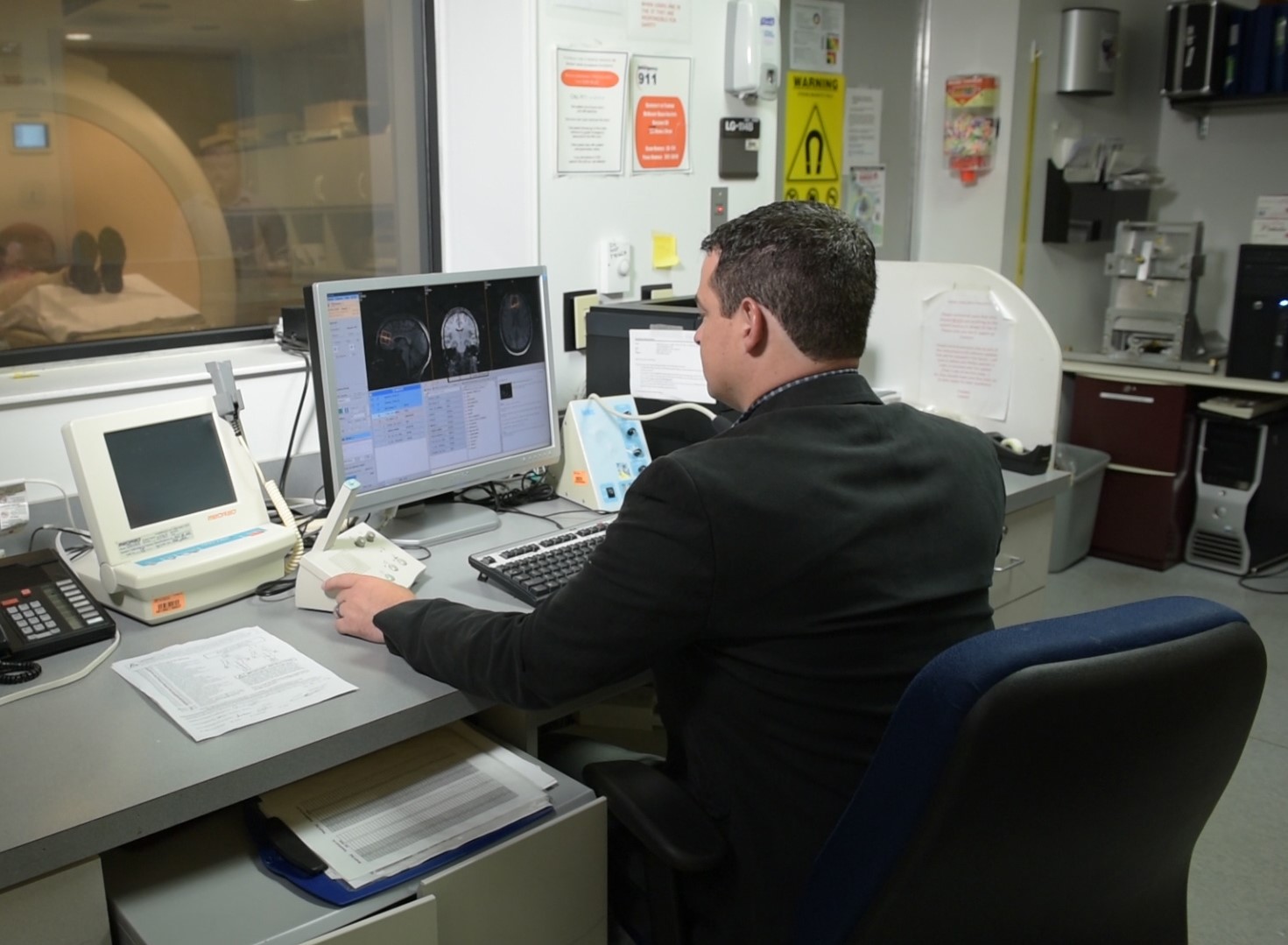 Adam Woods, associate director the Center for Cognitive Aging and Memory, conducts scans on a patient