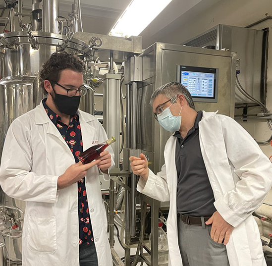 Nicholas Wendrick, left, and Andrew MacIntosh look at carbonated wine in the lab. Photo courtesy of Andrew MacIntosh