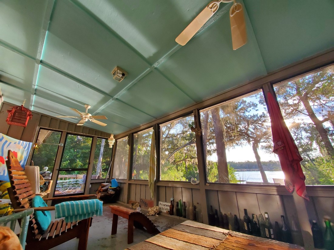 An interior shot of author Charles Hailey's porch overlooking a lake.