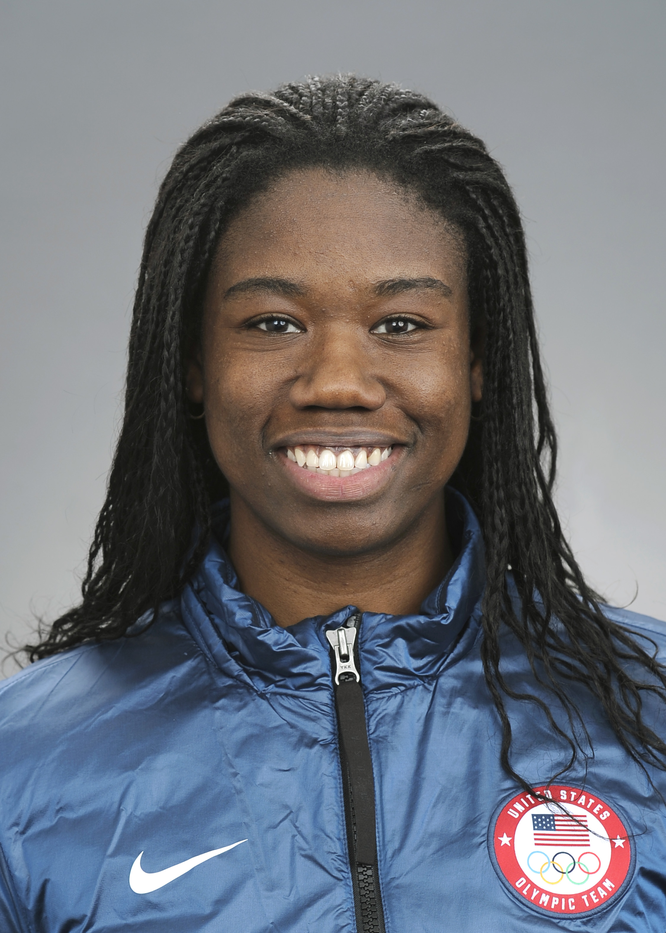 A close up of an African-American woman wearing a blue jacket.