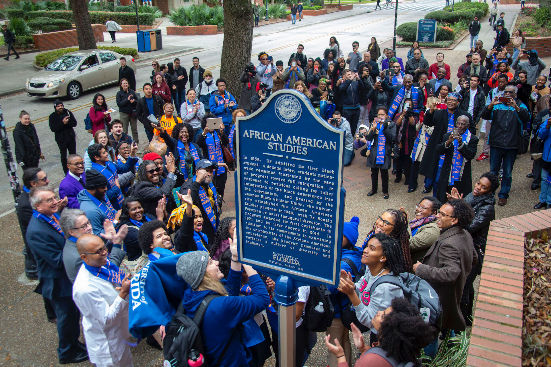 Dozens surround a historical marker which commemorates African Americans Studies 