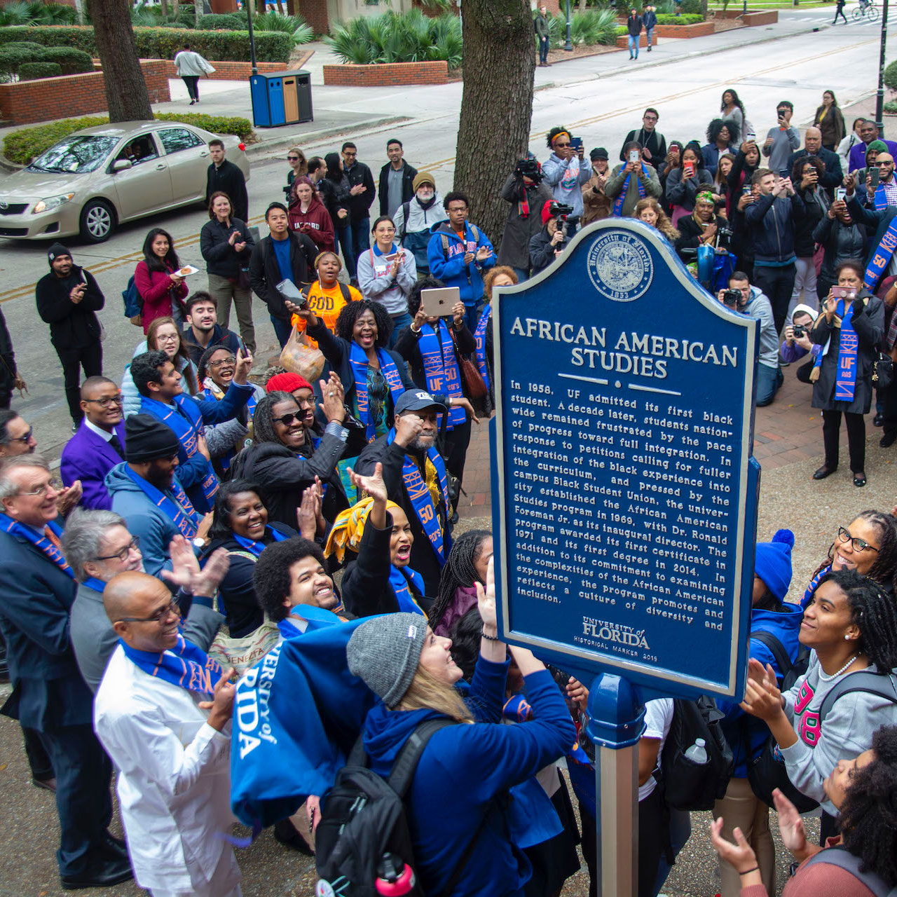 Dozens surround a historical marker which commemorates African Americans Studies 