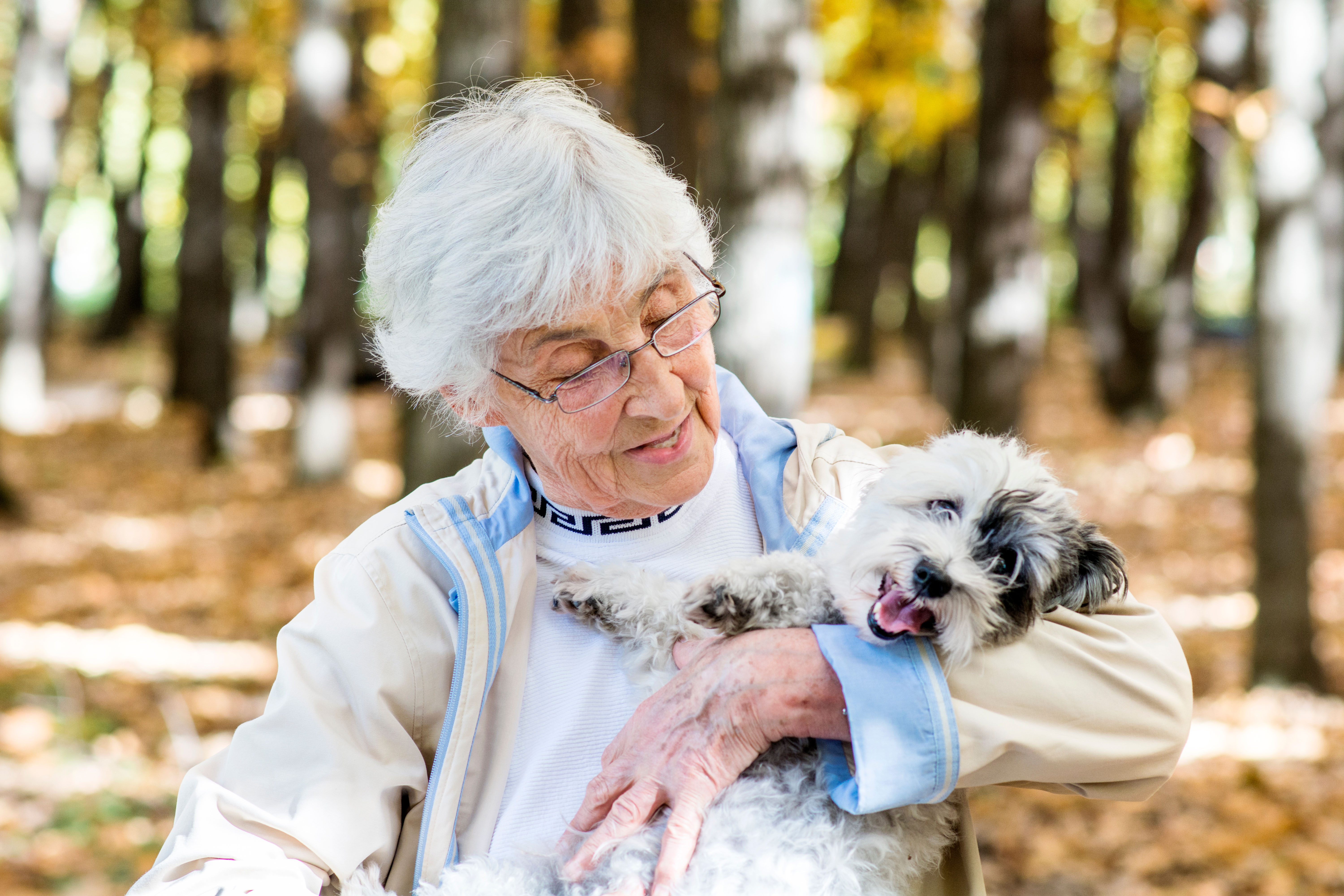 Older woman holding dog