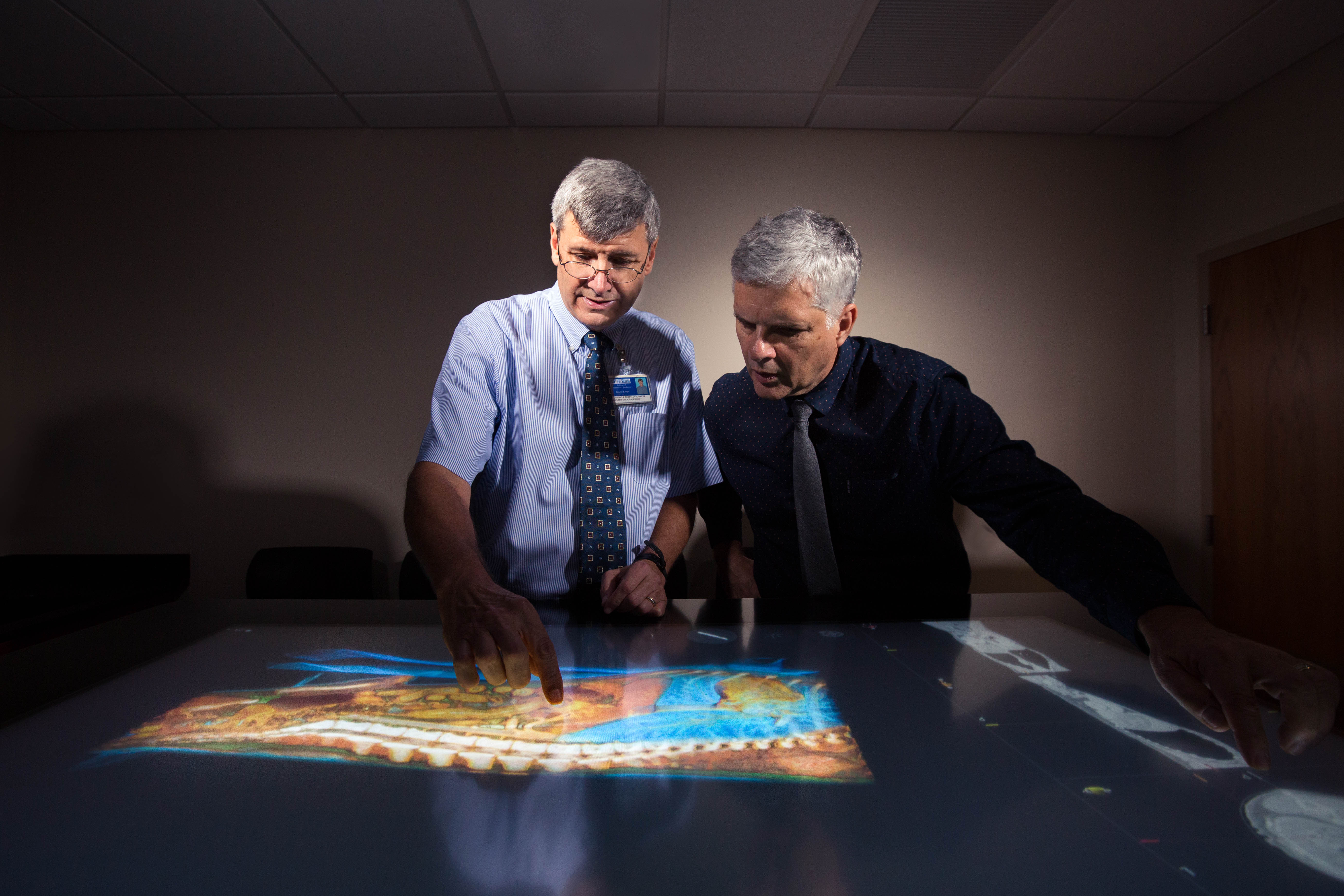 Two men study a smart map.