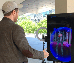 A man uses an augmented reality art installation. 