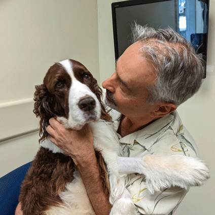 A man holding a dog.