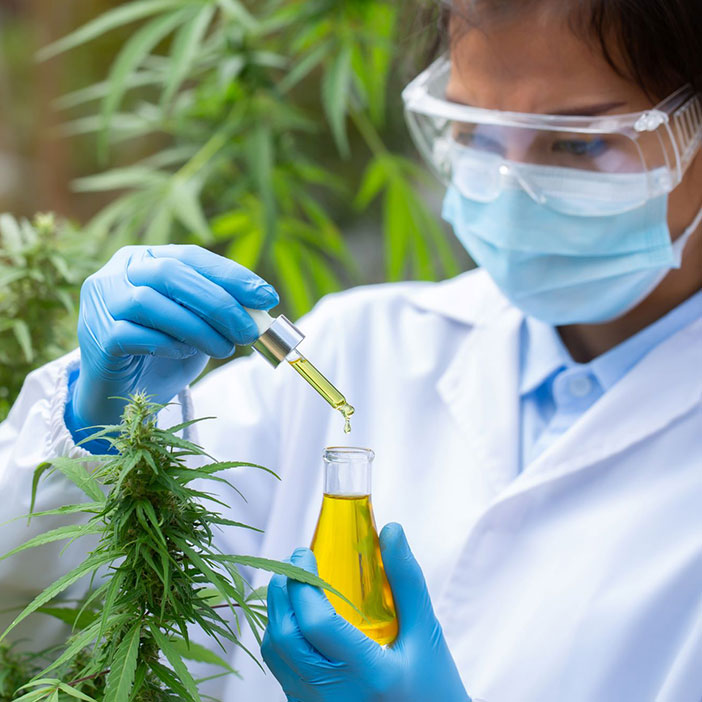 A scientist holds a beaker 