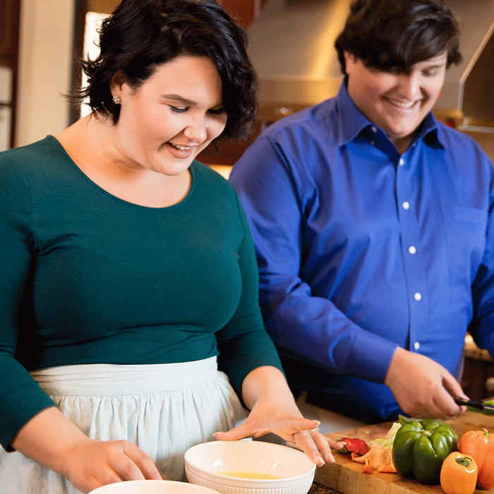 A man and woman make a meal together.