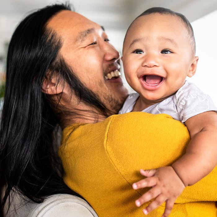 A man plays with an infant child