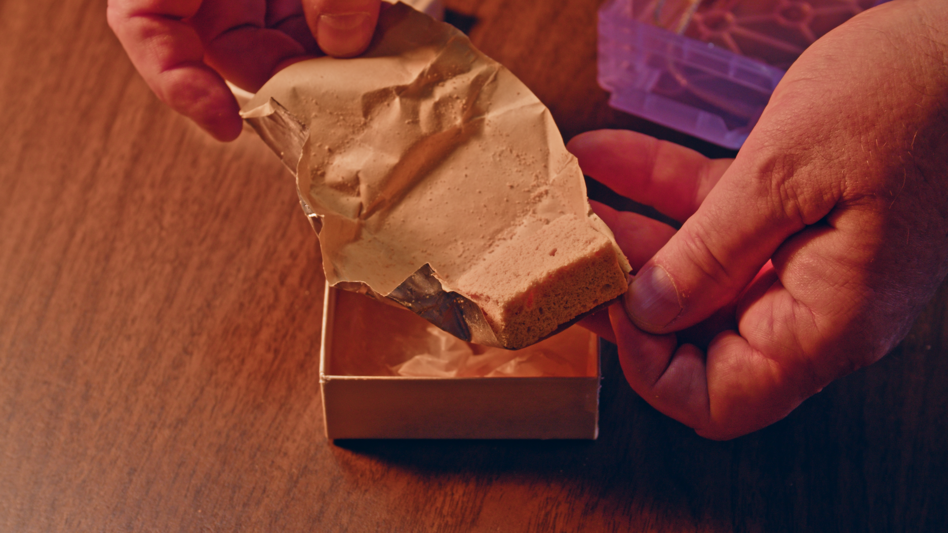 A slice of cake wrapped in foil in a special box.