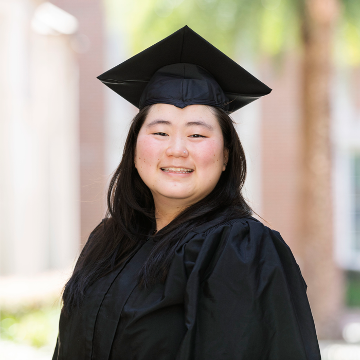 A woman in graduation regalia 