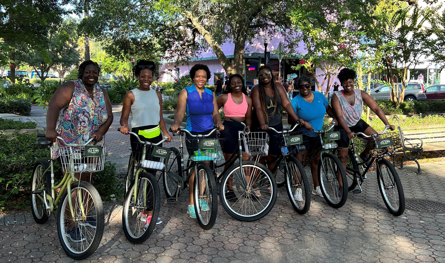 A group of women sitting on bicycles.