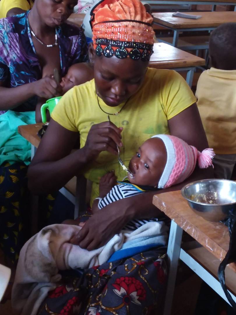 A woman feeds her baby.