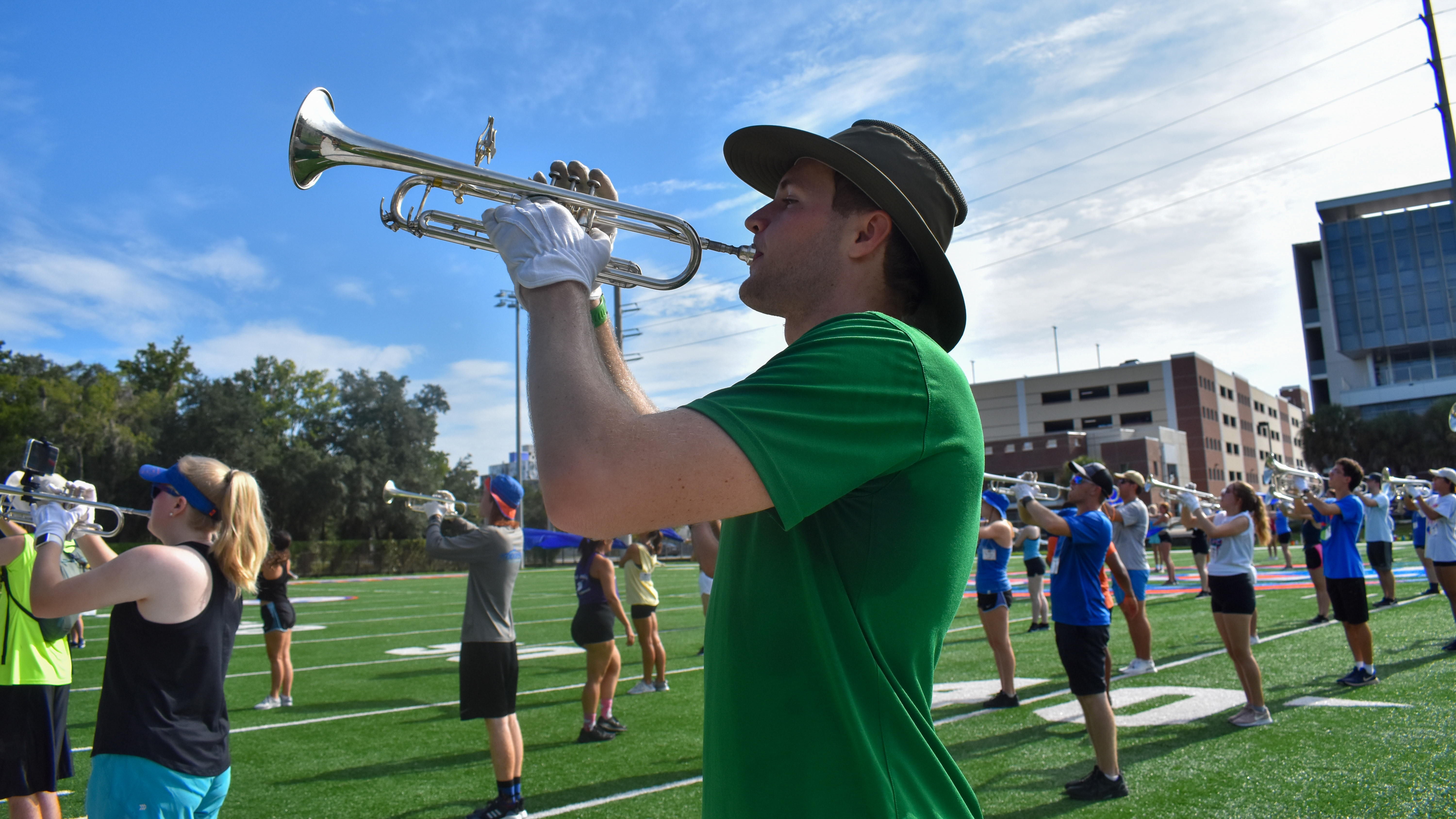 A student plays a trumpet outside.