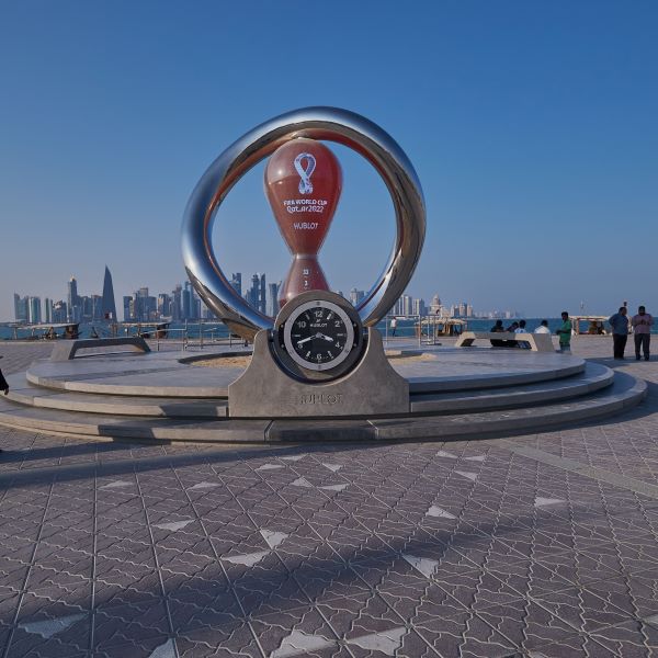 World Cup statue with countdown clock at harbor in Qatar