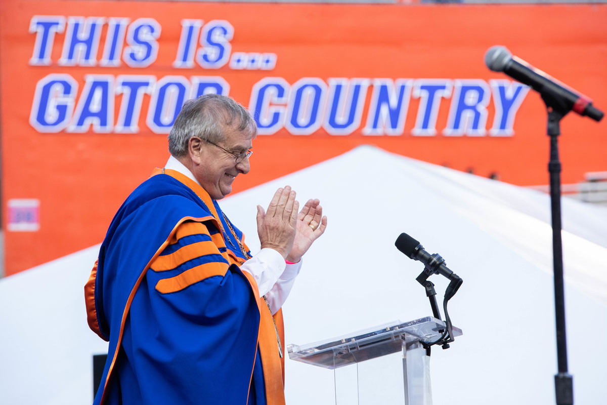 UF President Kent Fuchs in the University of Florida football stadium in graduation regalia.