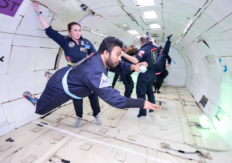 a man maneuvers in zero-gravity