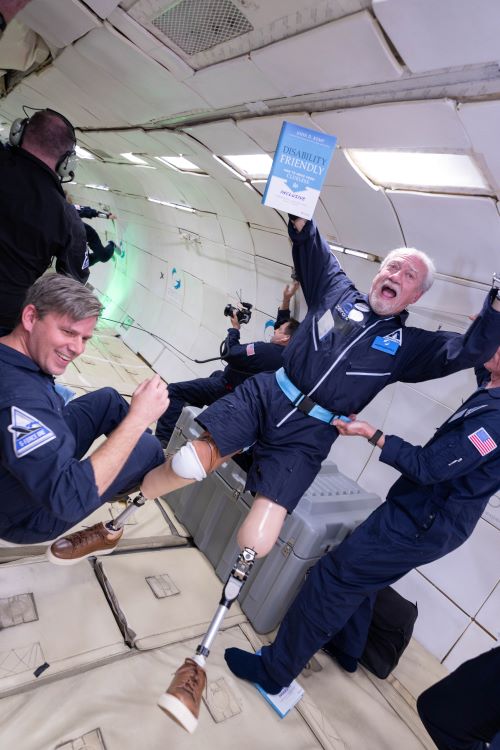 a man floats with four prosthetic limbs outreached onboard the parabolic flight