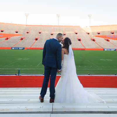 A couple kissing in wedding attire in The Swamp at the University of Florida.