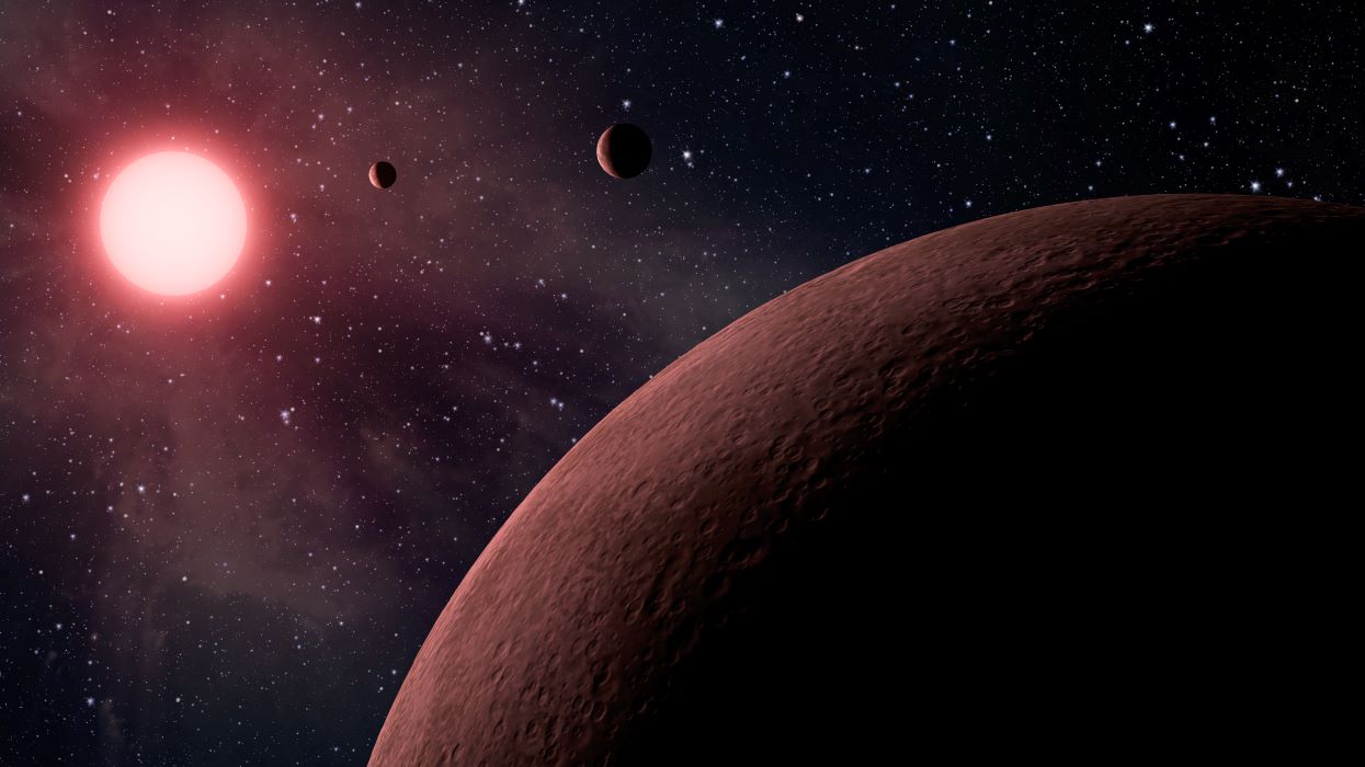 An artist's conception of three exoplanets orbiting a red star