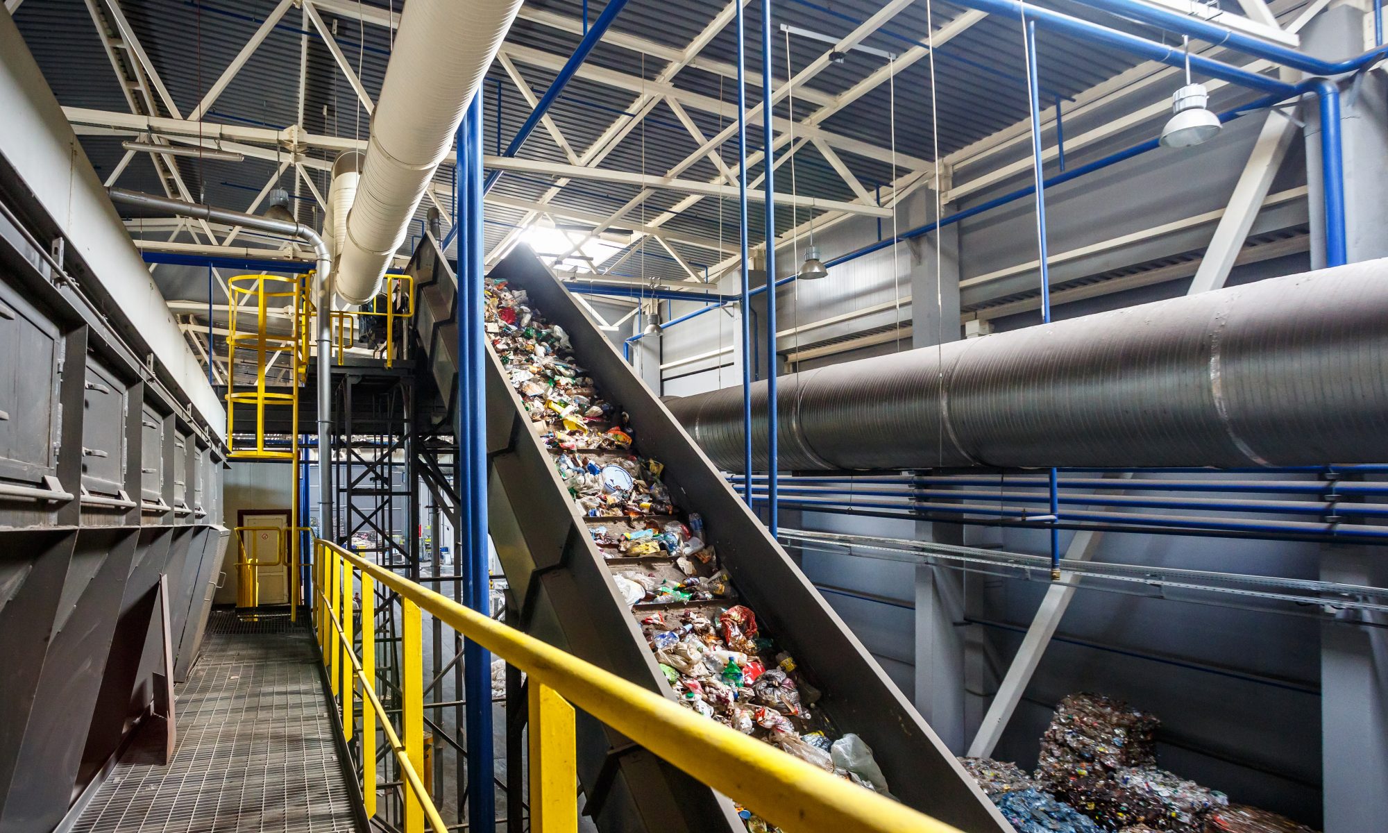 plastic moving down a conveyer belt in a recycling plant