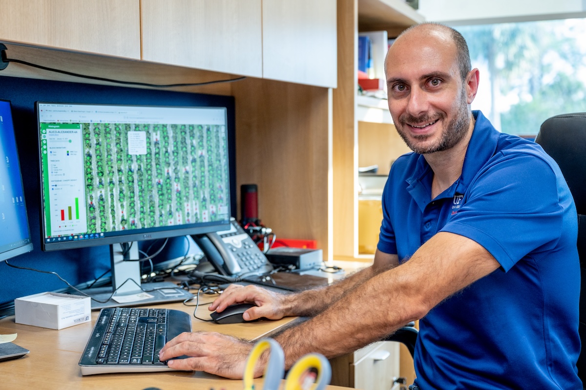 researcher at desk with computer screen showing grove