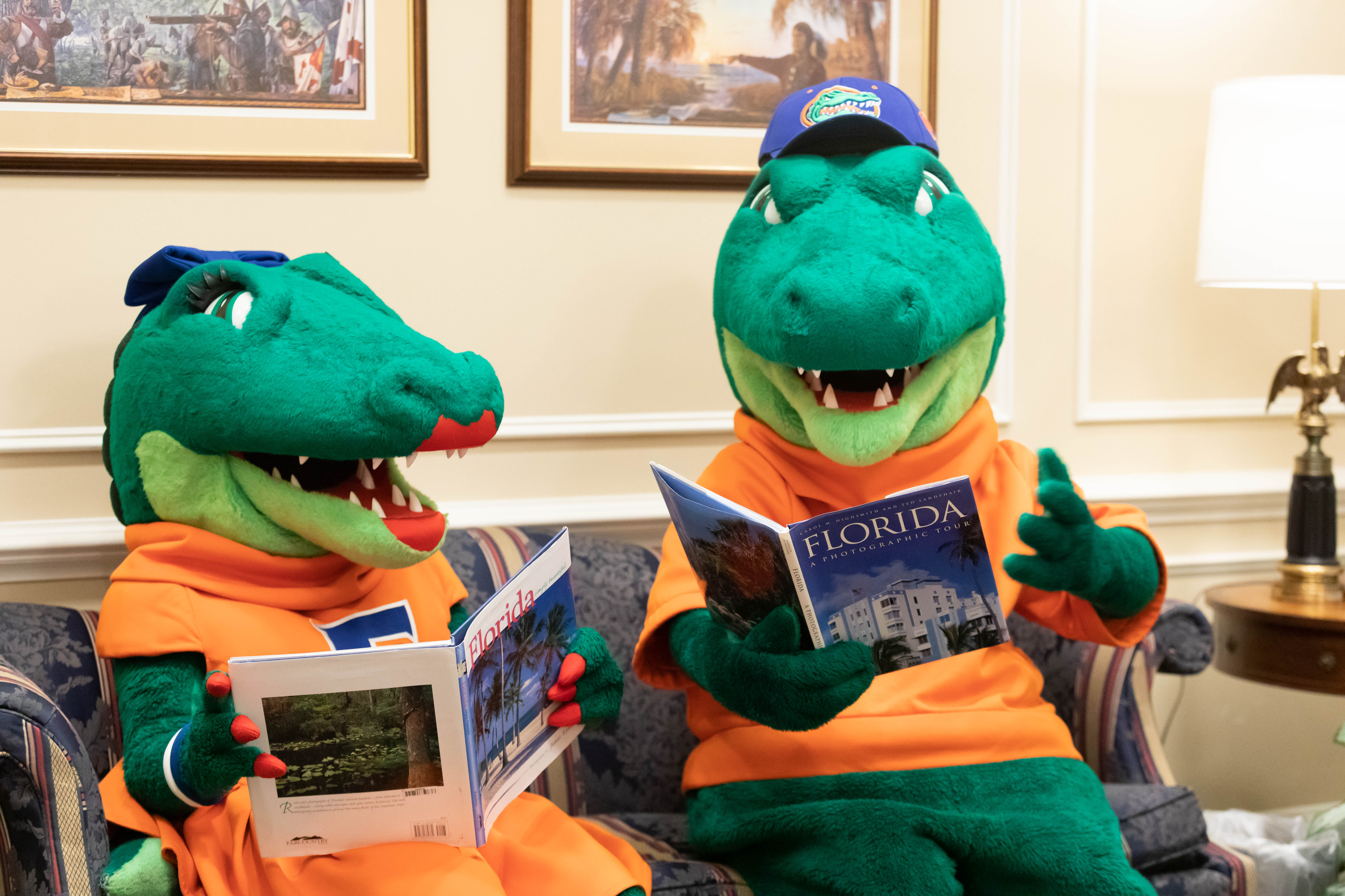 The University of Florida mascots, Albert and Alberta, read books about Florida in the state capitol.