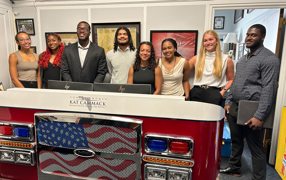 A group of student athletes pose for a photo.