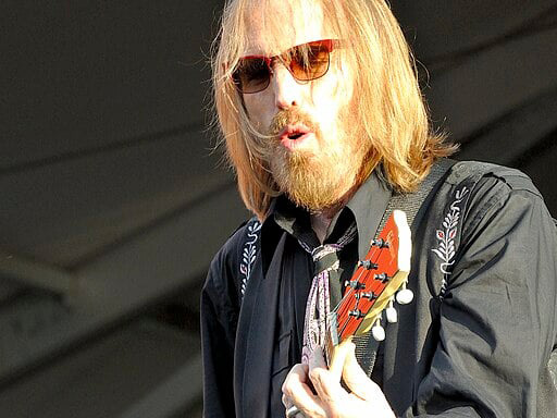 Tom Petty performing on stage.