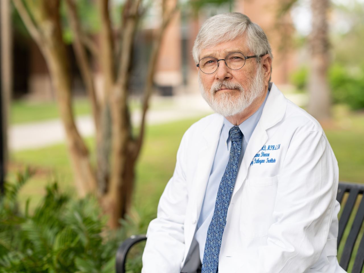 Glenn Morris seated wearing a lab coat