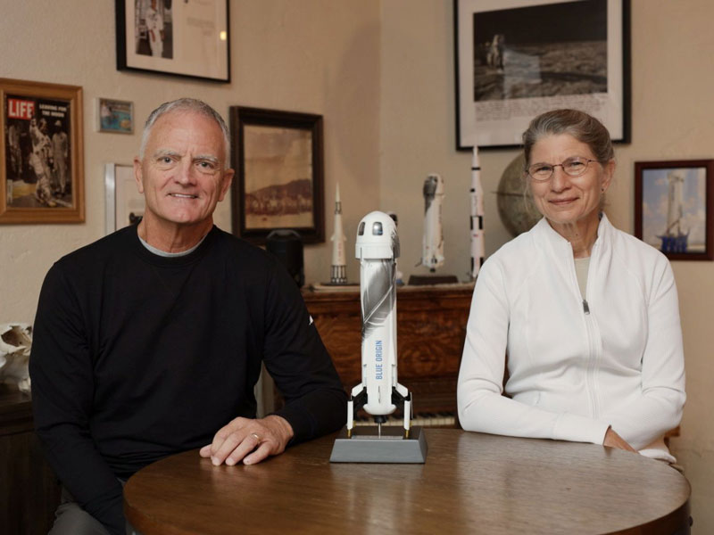 Rob Ferl and Anna-Lisa Paul pose at a table with a model rocket between them.