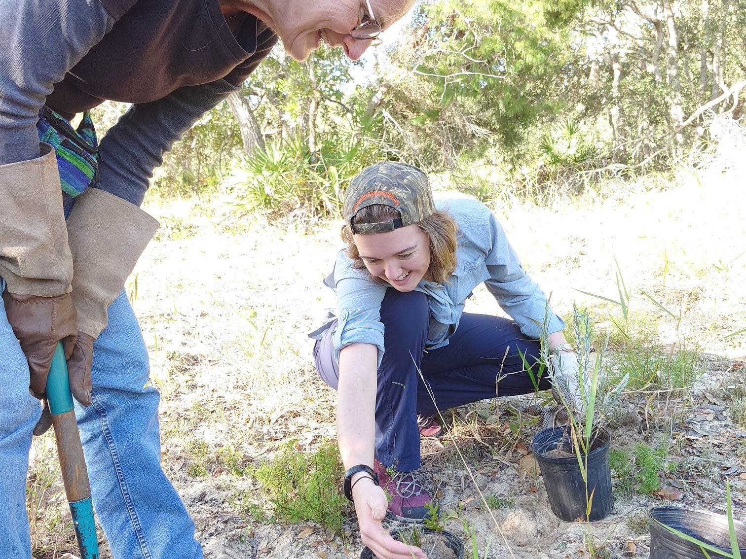 Certified Florida master naturalist Laura Bennett-Kimble (left) works with Rose Schnabel (right) on a plant rescue assignment