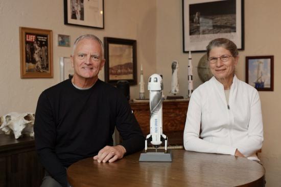 Rob Ferl and Anna-Lisa Paul pose at a table with a model rocket between them.