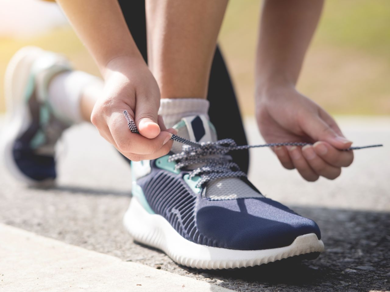 A close up view of a person tying a running shoe