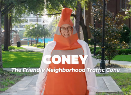 A man dressed in a traffic cone costume.