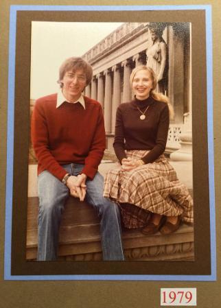 A young man and woman sitting on a set of steps.