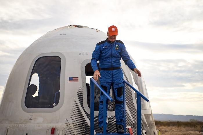 Rob Ferl steps out of a returned Blue Origin capsule