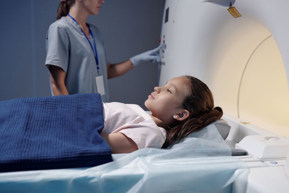 a female child is on table before a CT scan begins